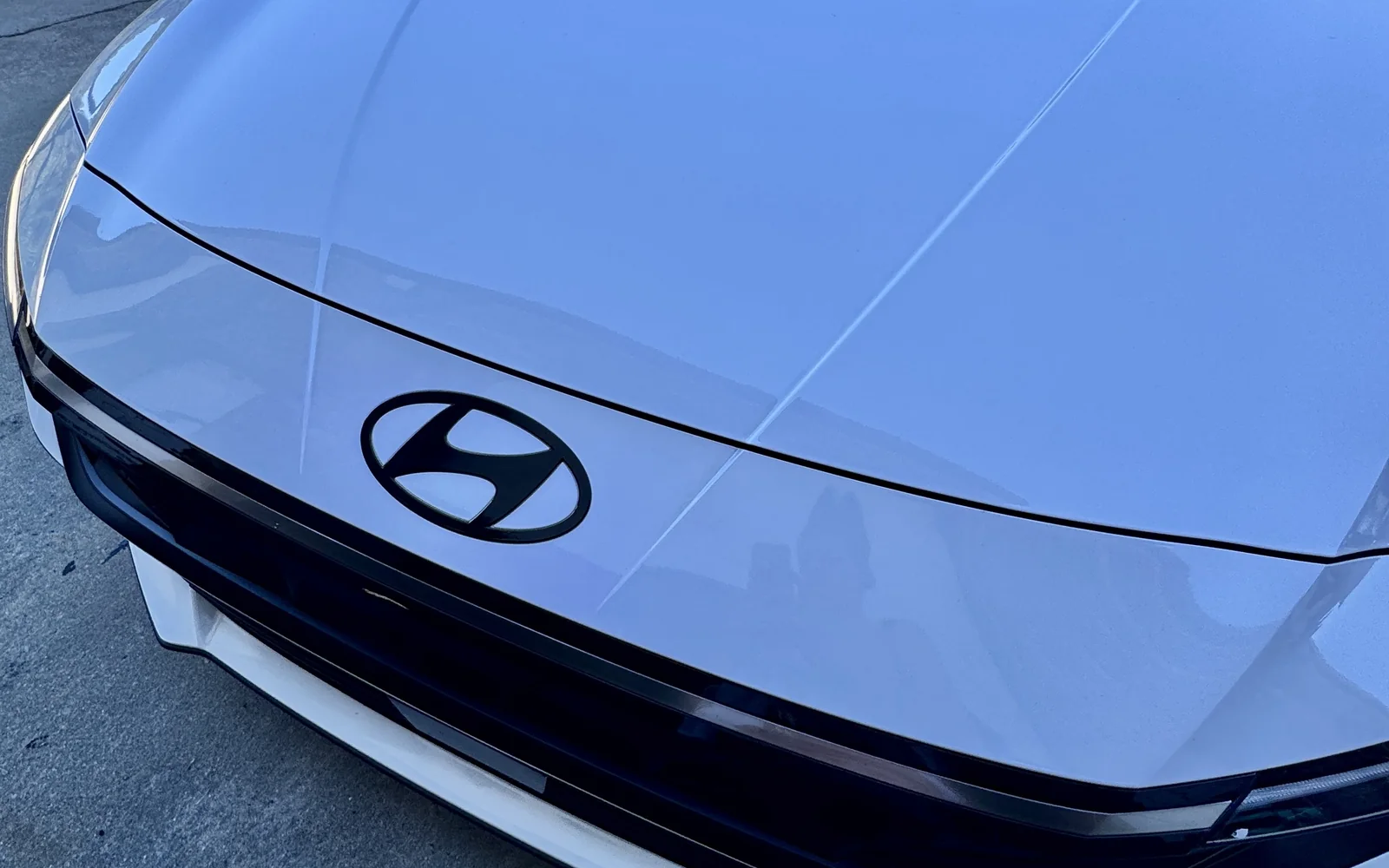 Hyundai Elantra hood with the front Hyundai emblem blacked out in gloss black