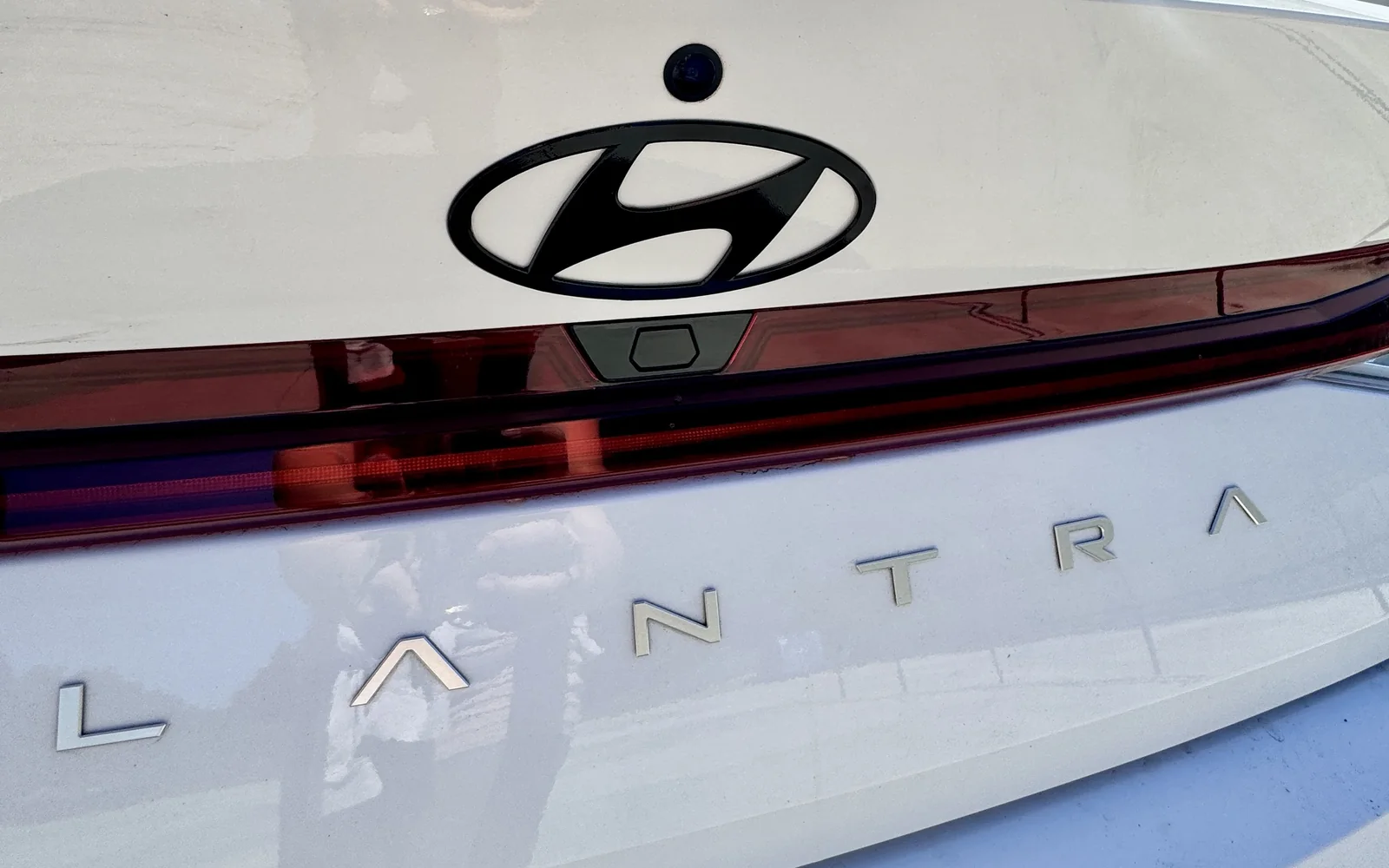 Hyundai Elantra trunk lid with the rear Hyundai emblem blacked out in gloss black and chrome Elantra lettering