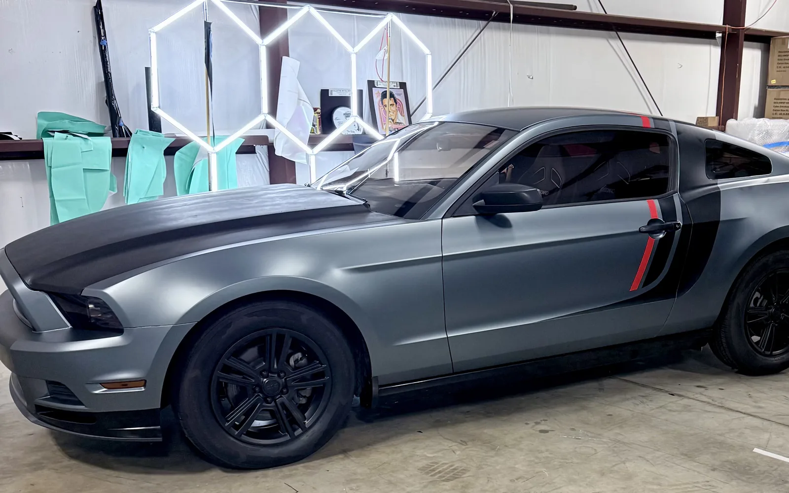 Ford Mustang satin metallic blue color change wrap with black hood and red accent stripes