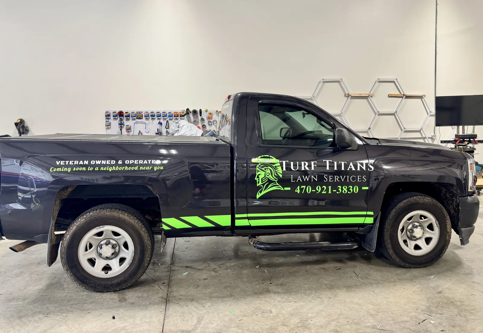 Turf Titans Lawn Services pickup with lettering and accent stripes